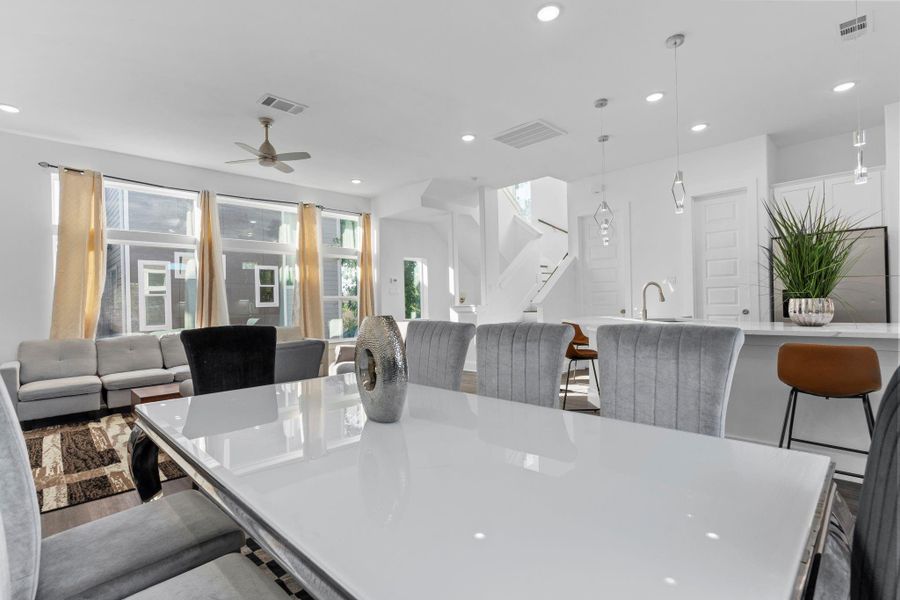 Cozy dining area with modern lighting and open views of the kitchen and the living area.