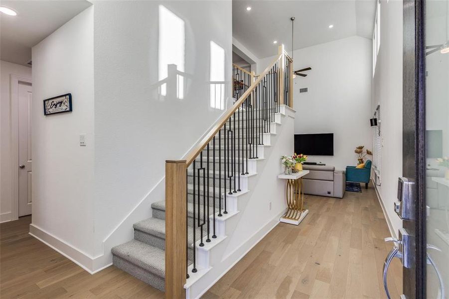 Staircase with wood finished floors, a ceiling fan, and recessed lighting Staircase with wood finished floors, a ceiling fan, and recessed lighting