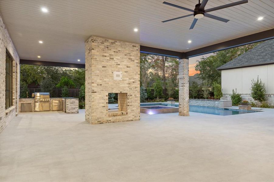 Outdoor patio with double fireplace and kitchen