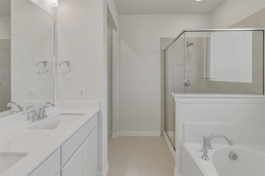 Bathroom featuring a dual vanity with undermount sinks, a walk-in shower with clear glass enclosure, a built-in soaking tub, and tile flooring Bathroom featuring a dual vanity with undermount sinks, a walk-in shower with clear glass enclosure, a built-in soaking tub, and tile flooring