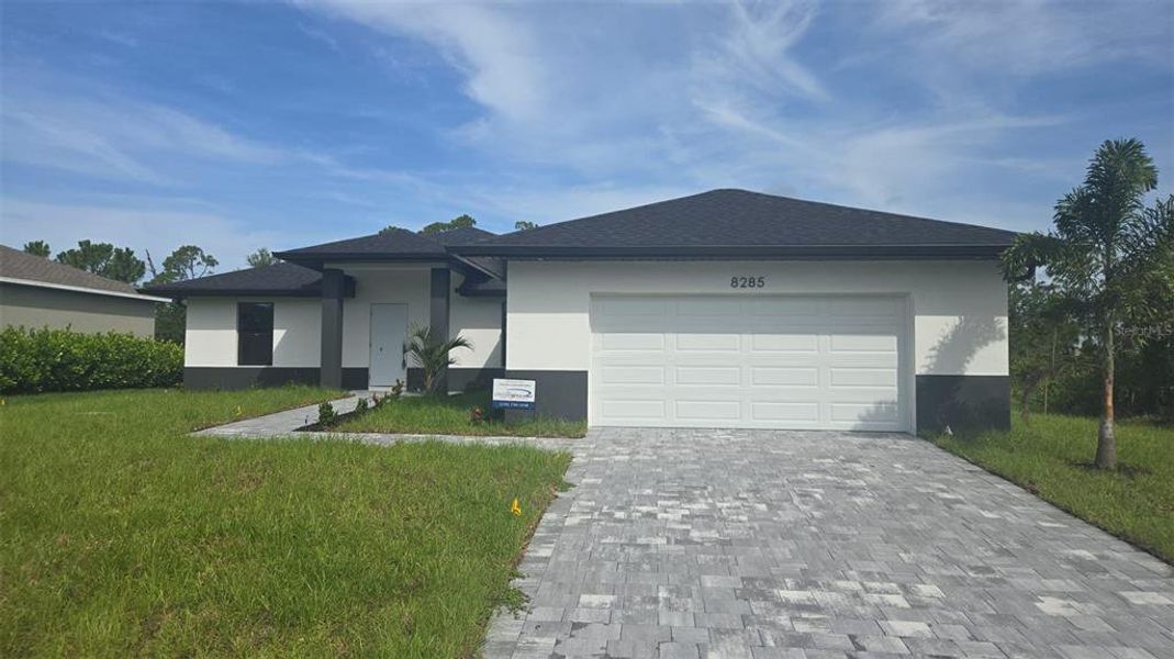 Front exterior of a new home in , Port Charlotte, FL, highlighting curb appeal (Image 2).