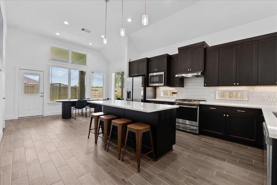 The heart of the home, this stunning kitchen features an oversized island with ample seating space, creating the perfect gathering spot for family, friends, and everyday conversations. The heart of the home, this stunning kitchen features an oversized island with ample seating space, creating the perfect gathering spot for family, friends, and everyday conversations.