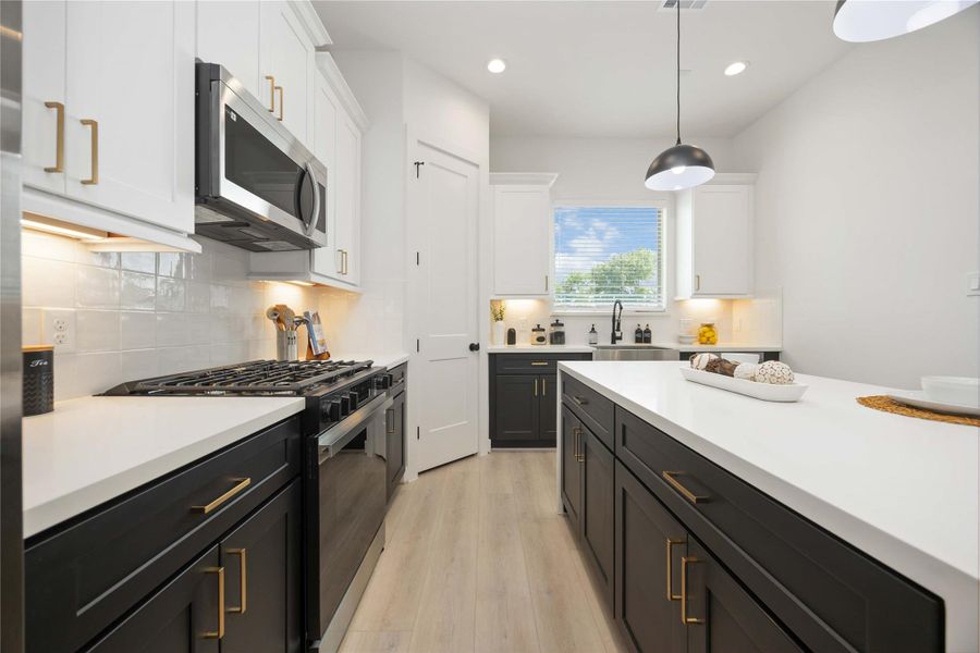 Island kitchen. Photo of the model home. Finishes & specifications may vary.