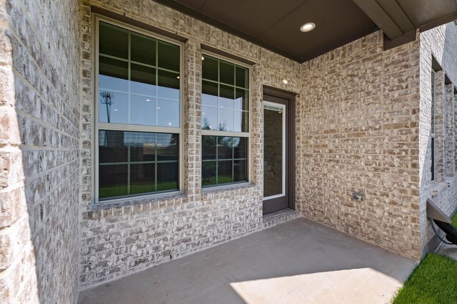 Front exterior of a new home in Main Street Village, Mansfield, TX, highlighting curb appeal (Image 27). Front exterior of a new home in Main Street Village, Mansfield, TX, highlighting curb appeal (Image 27).