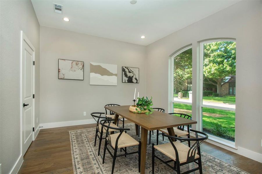 Dining room with dark hardwood / wood-style flooring