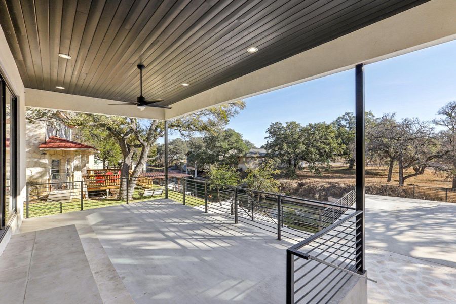 The rear covered porch provides immediate access to the outdoors, serving as a peaceful transition between the versatile first-floor interior and the natural beauty of the preserve just beyond the fence
