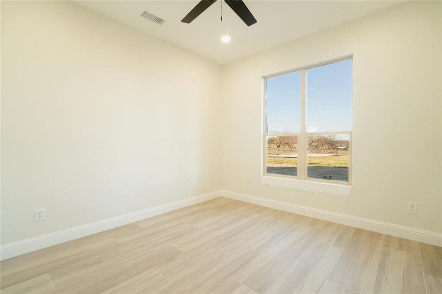 Spare room with baseboards, visible vents, ceiling fan, light wood-style flooring, and recessed lighting