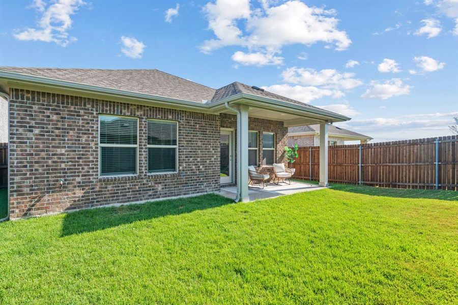 Back of house featuring a patio area, brick siding, and roof with shingles Back of house featuring a patio area, brick siding, and roof with shingles