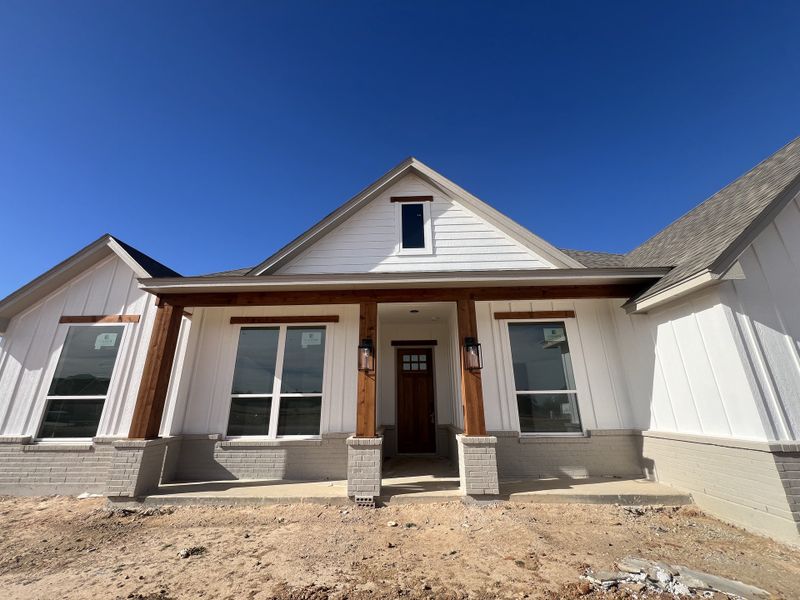 Front exterior of a new home in Zion Valley, Poolville, TX, highlighting curb appeal (Image 8).