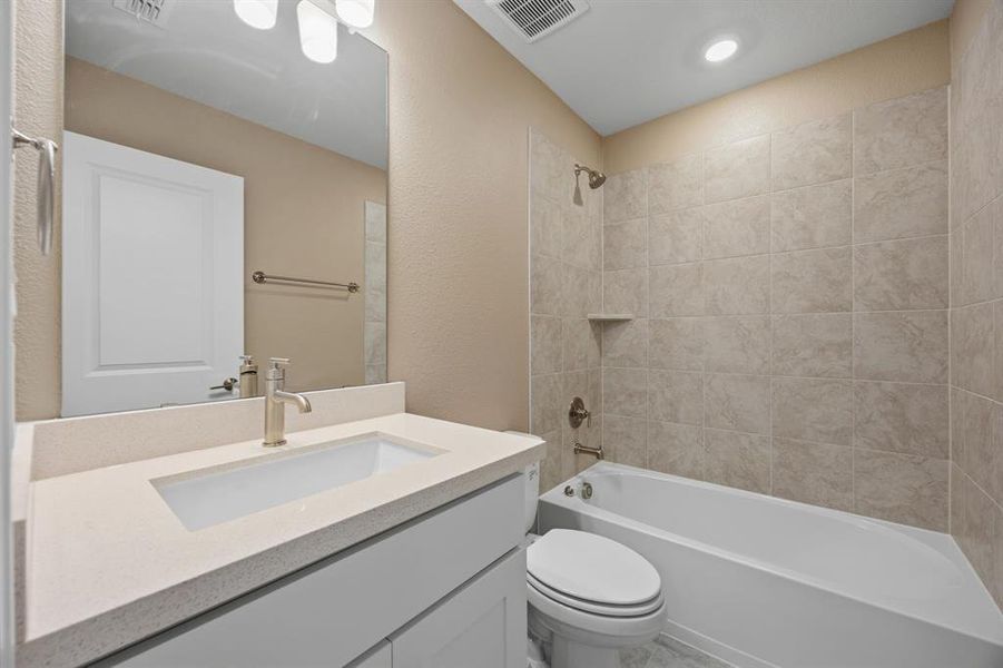 2nd level Full bathroom featuring vanity and shower / tub combination. This is next to the 1st bedroom upstairs.