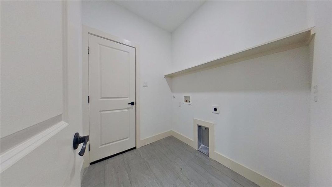 Laundry room with light wood-type flooring, washer hookup, and hookup for an electric dryer