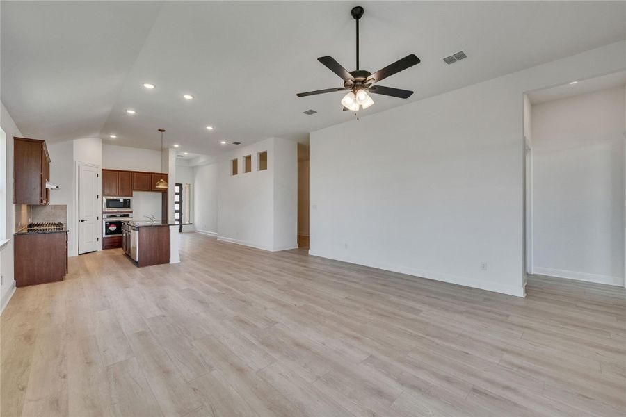 Unfurnished living room with light wood-style floors, recessed lighting, and a ceiling fan Unfurnished living room with light wood-style floors, recessed lighting, and a ceiling fan