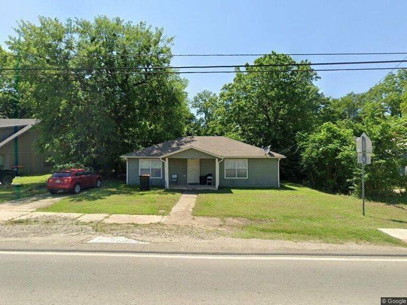 Bungalow-style house with a front yard and covered porch