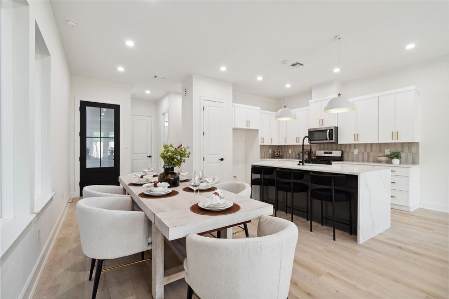 An elegant dining space positioned between the kitchen and living area, with ample space for a large table.