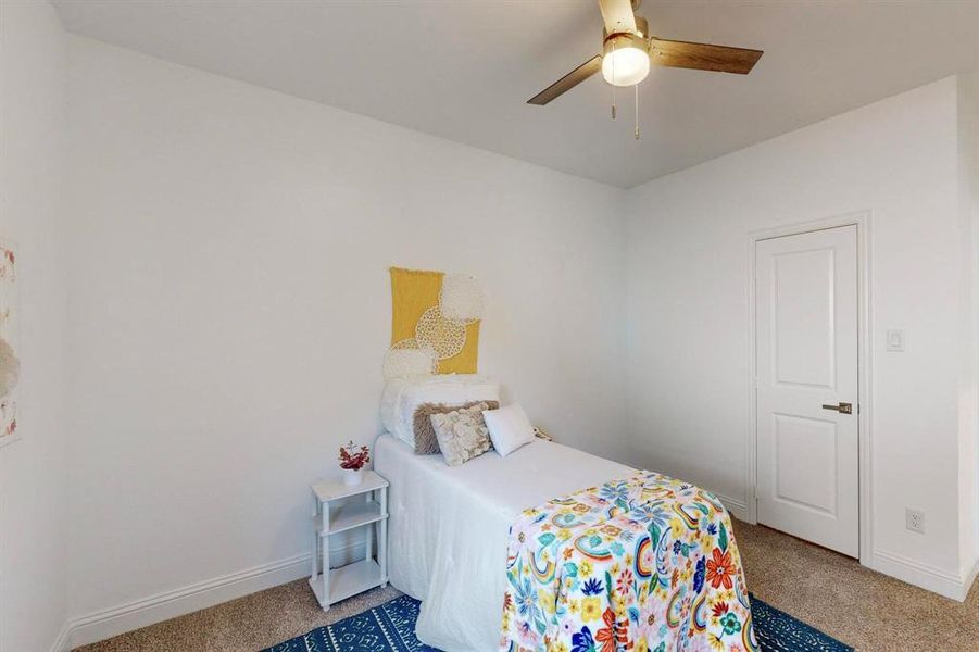 Carpeted bedroom with ceiling fan