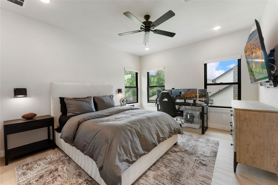 Another spacious secondary bedroom that offers natural light and designer sconces.