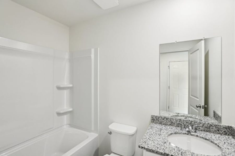 A bathroom with a marble countertop.