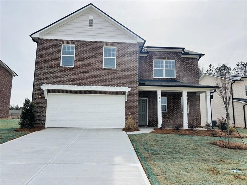 Front exterior of a new home in Kendall Grove, McDonough, GA, highlighting curb appeal (Image 1). Front exterior of a new home in Kendall Grove, McDonough, GA, highlighting curb appeal (Image 1).
