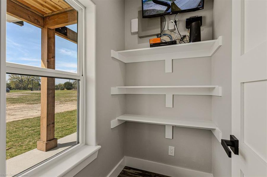 Media Closet off of Utility Room. Alarm system comes with 1 year of free monitoring.