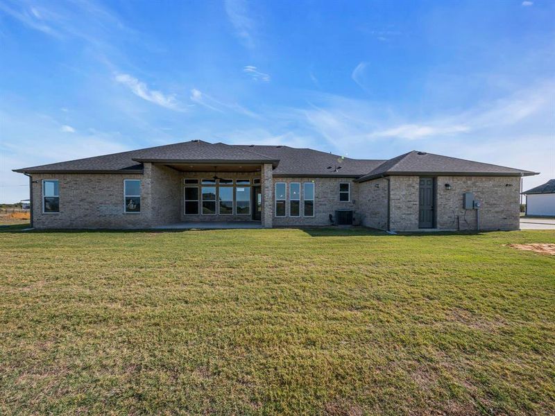 Rear view of property with central AC, a yard, a patio, and ceiling fan