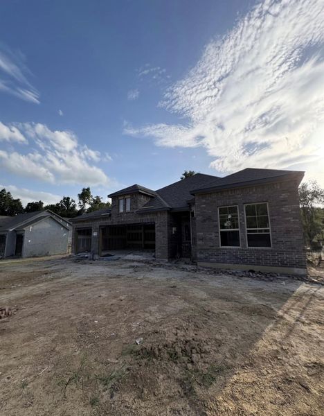 Front exterior of a new home in Encino Estates, Dayton, TX, highlighting curb appeal (Image 1). Front exterior of a new home in Encino Estates, Dayton, TX, highlighting curb appeal (Image 1).