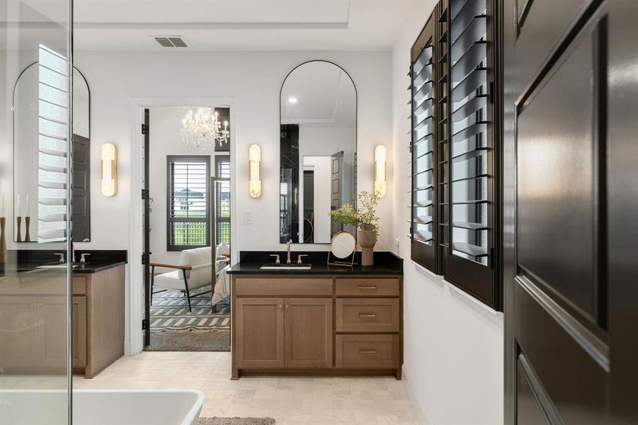 Full bathroom with vanity, ensuite bathroom, a chandelier, a bathtub, and light floors Full bathroom with vanity, ensuite bathroom, a chandelier, a bathtub, and light floors