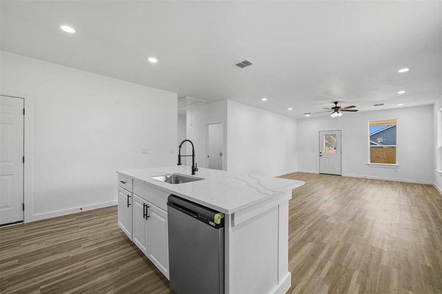 Kitchen featuring white cabinets, dishwasher, recessed lighting, light stone counters, and ceiling fan Kitchen featuring white cabinets, dishwasher, recessed lighting, light stone counters, and ceiling fan