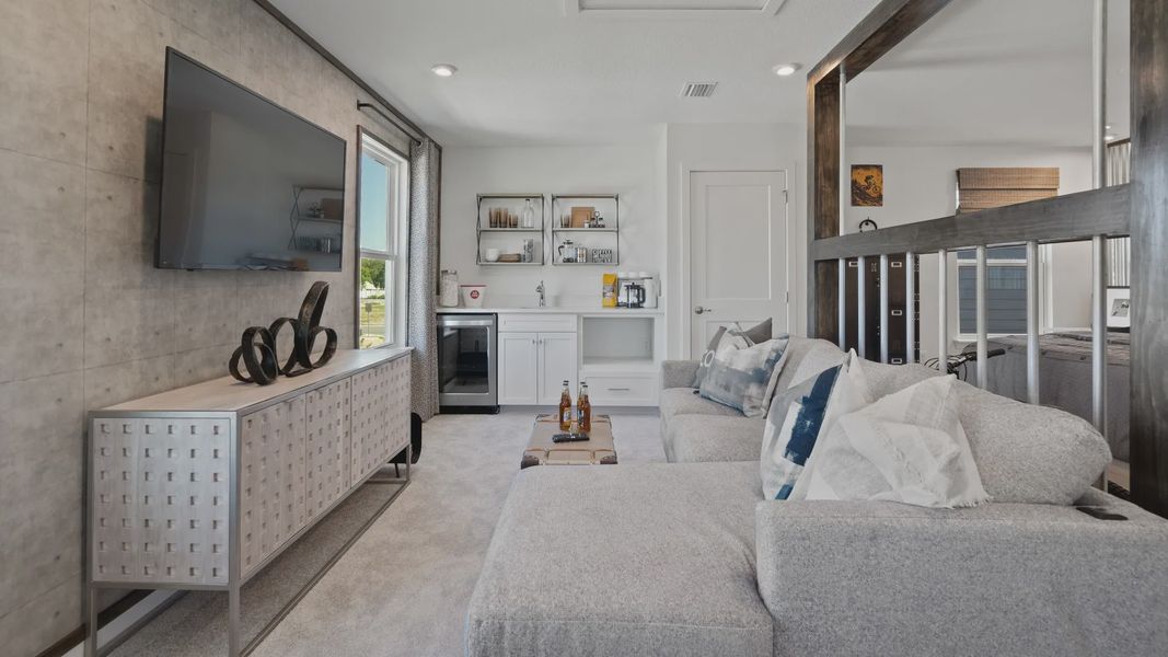 Above garage retreat space with wet bar in a DRB Homes Ambersweet model at the Trinity Place community. Above garage retreat space with wet bar in a DRB Homes Ambersweet model at the Trinity Place community.