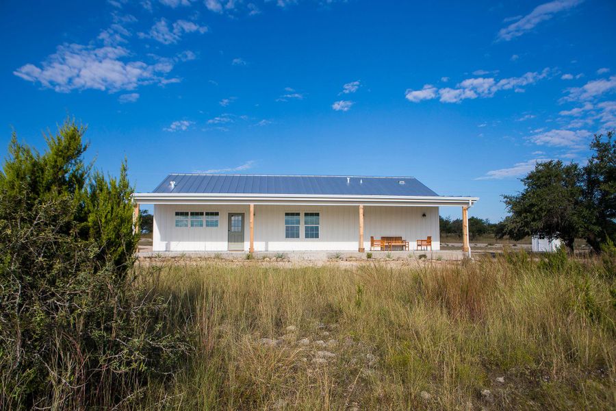 Back of property with a metal roof and a porch Back of property with a metal roof and a porch