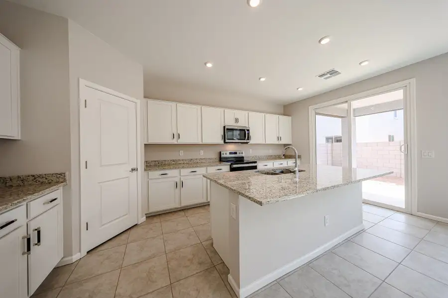 A kitchen with white cabinets.