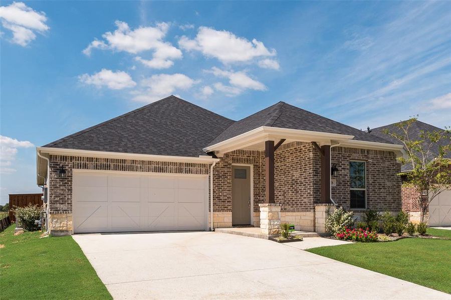 Front exterior of a new home in Spiritas Ranch, Little Elm, TX, highlighting curb appeal (Image 1). Front exterior of a new home in Spiritas Ranch, Little Elm, TX, highlighting curb appeal (Image 1).