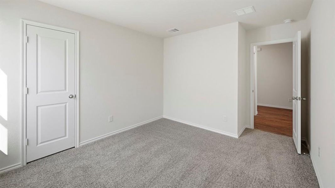 Unfurnished bedroom featuring carpet floors and baseboards