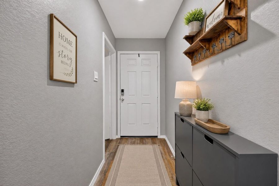 Step inside to a welcoming entryway with neutral finishes that leads toward the home's main living areas. Step inside to a welcoming entryway with neutral finishes that leads toward the home's main living areas.