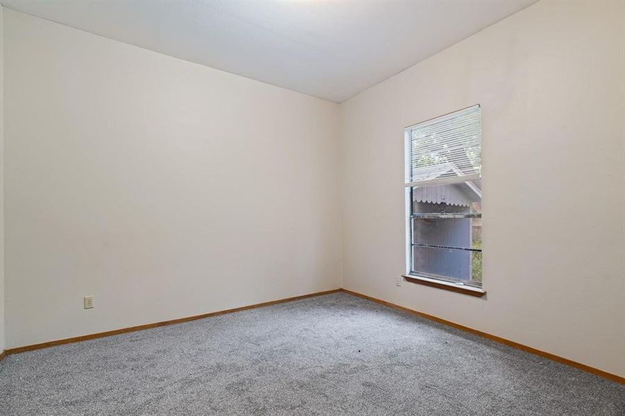 Carpeted empty room featuring baseboards Carpeted empty room featuring baseboards