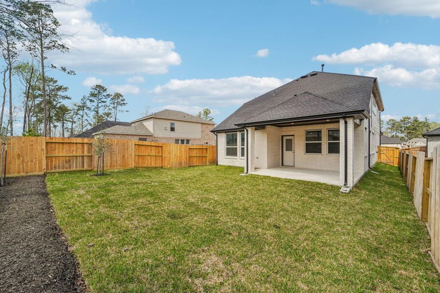 Exterior details and patio area of a home in The Woodlands Hills, Willis (Image 16).