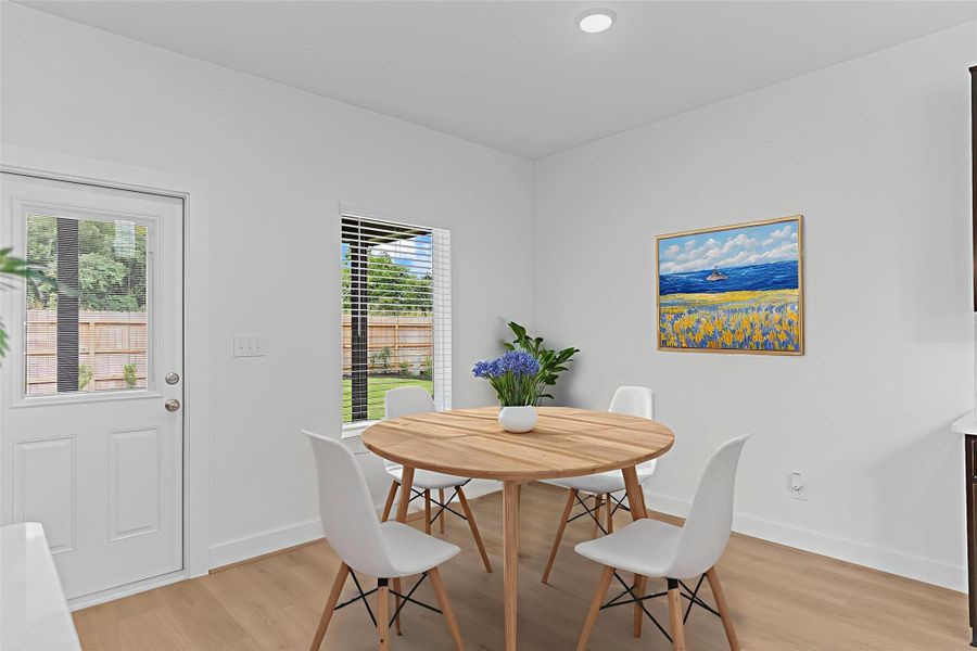 Bright and welcoming breakfast area nestled between the kitchen and backyard, featuring large windows that bring in natural light—perfect for casual meals or a quiet morning coffee. *Virtually Staged Photo* **Image Representative of Plan Only and May Vary as Built**.