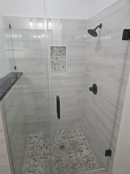 Bathroom with a shower with shower door