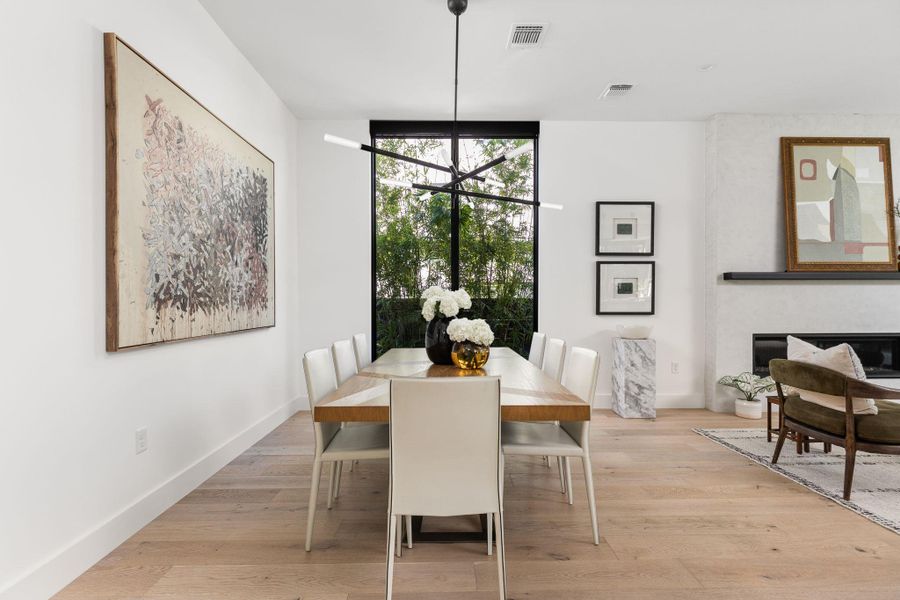 Dining area featuring light wood-style floors and a chandelier Dining area featuring light wood-style floors and a chandelier