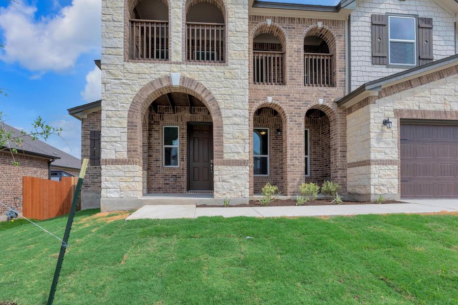 Front exterior of a new home in Salerno - Hallmark Collection, Round Rock, TX, highlighting curb appeal (Image 19). Front exterior of a new home in Salerno - Hallmark Collection, Round Rock, TX, highlighting curb appeal (Image 19).