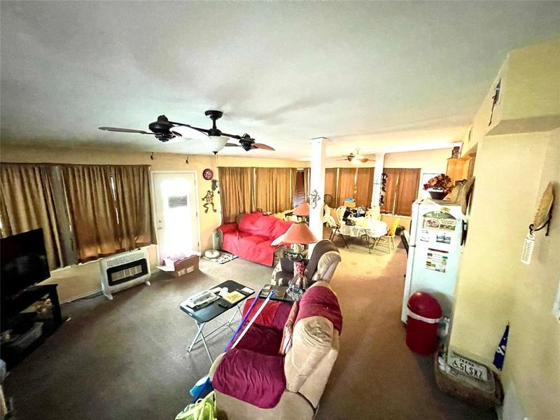 Living room with ceiling fan and heating unit Living room with ceiling fan and heating unit