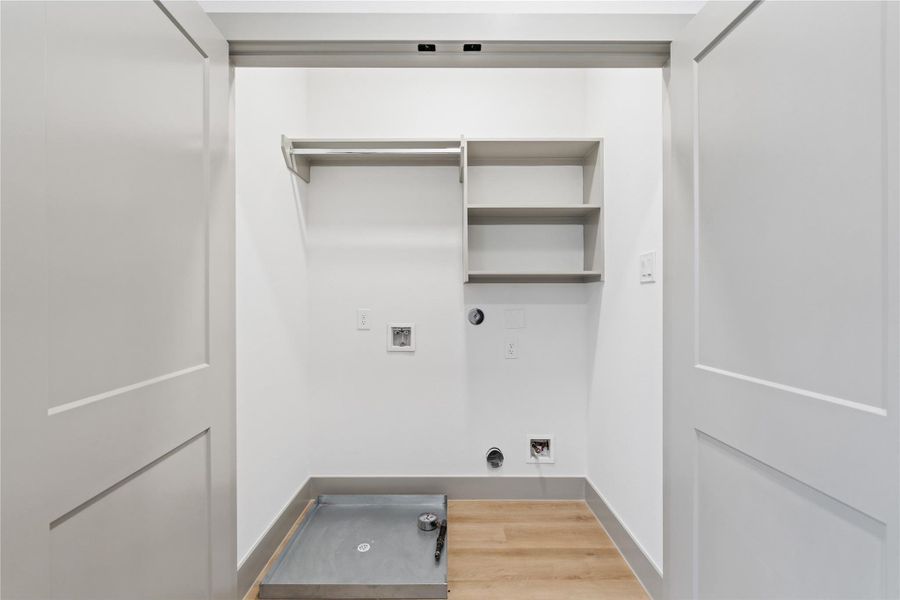 Tucked behind sleek double doors, this thoughtfully designed utility room maximizes function with clean, built-in shelving and a full hanging rod—perfect for streamlined laundry days. Neutral tones and minimalist finishes keep the space bright and refined, proving that even the most practical corners of a home can be elevated with intentional design.