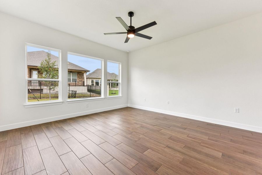 Spare room featuring wood tiled floors and a ceiling fan