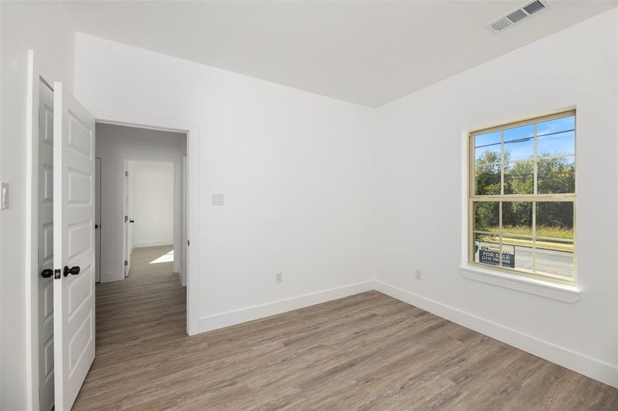 Empty room with wood finished floors and baseboards Empty room with wood finished floors and baseboards