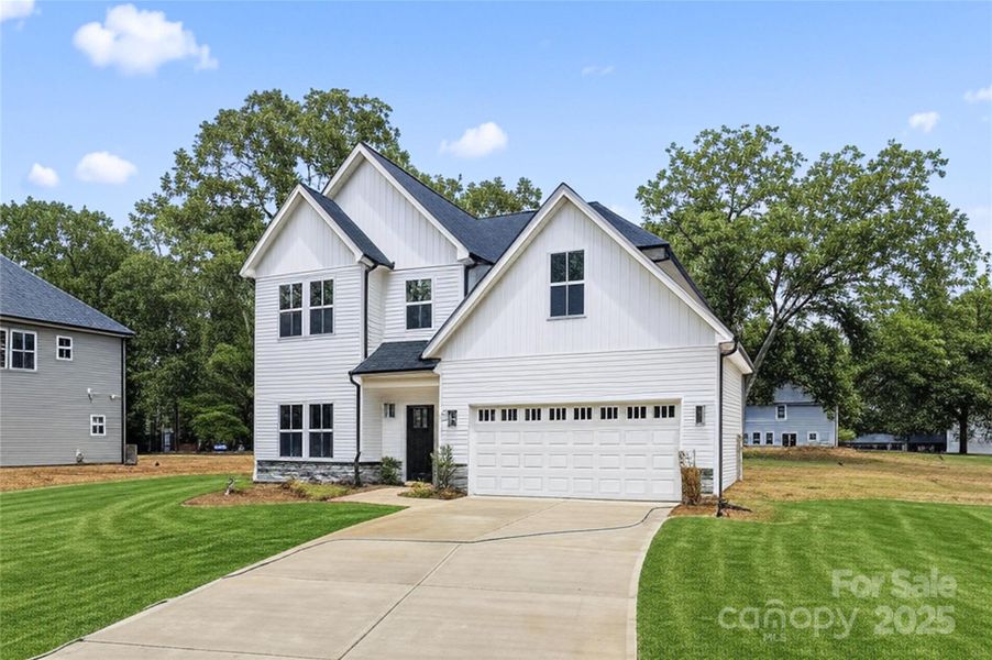 Front exterior of a new home in , Harrisburg, NC, highlighting curb appeal (Image 1). Front exterior of a new home in , Harrisburg, NC, highlighting curb appeal (Image 1).