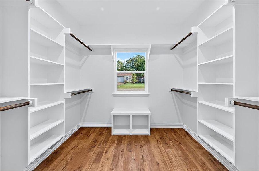Spacious closet featuring light wood finished floors Spacious closet featuring light wood finished floors