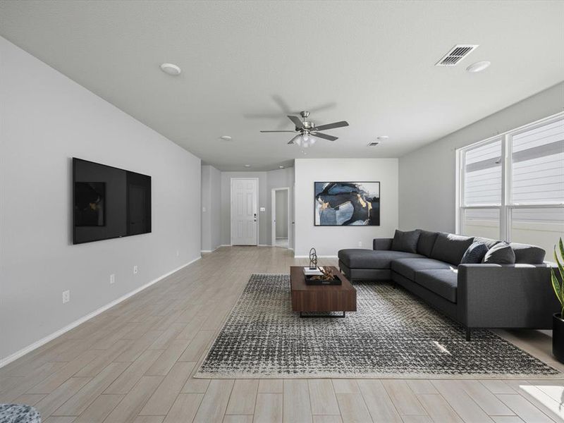 Virtually Staged-Living room featuring wood tiled floors, a ceiling fan, and recessed lighting Virtually Staged-Living room featuring wood tiled floors, a ceiling fan, and recessed lighting