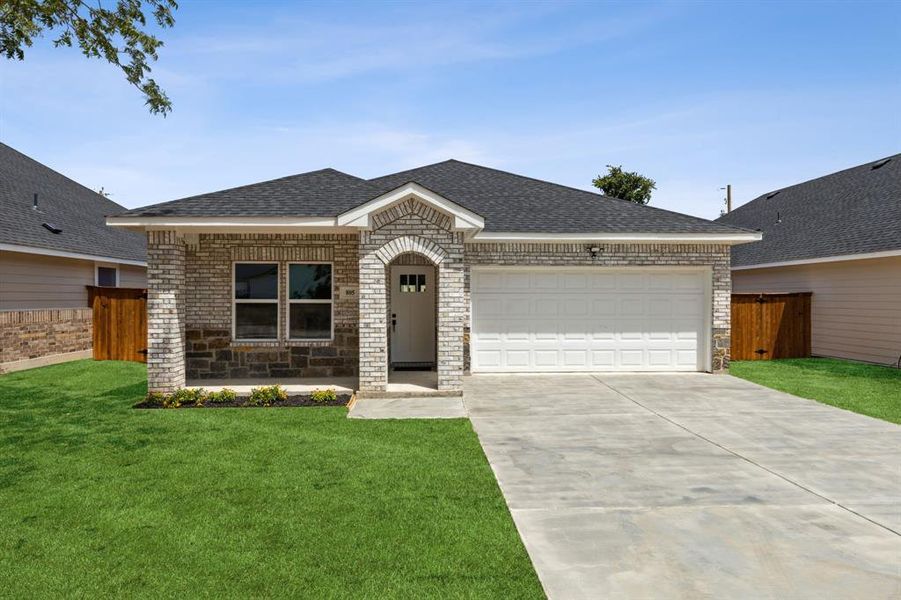 Single story home with a garage and a front yard