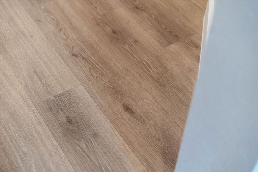 The photo highlights the Revwood laminate flooring in Sail Cloth which flows throughout the main living areas.