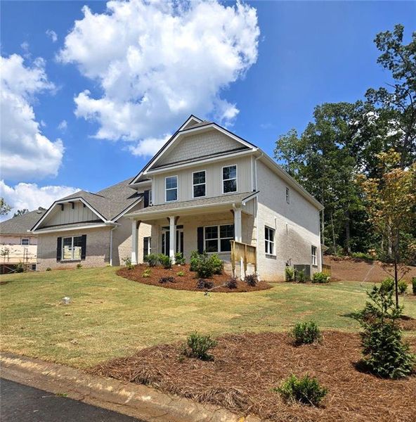 Front exterior of a new home in Mirror Lake at South Harbour, Villa Rica, GA, highlighting curb appeal (Image 17).