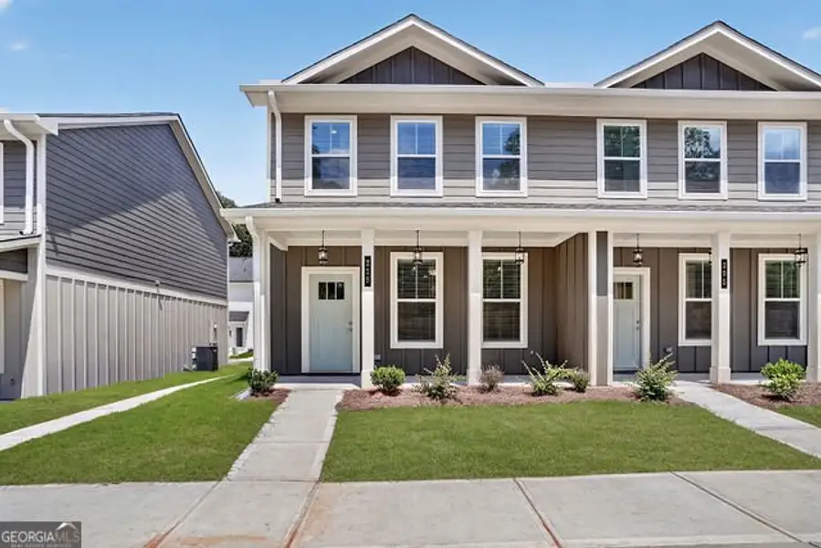 Front exterior of a new home in The Cottages at East Lanier, Fayetteville, GA, highlighting curb appeal (Image 1). Front exterior of a new home in The Cottages at East Lanier, Fayetteville, GA, highlighting curb appeal (Image 1).